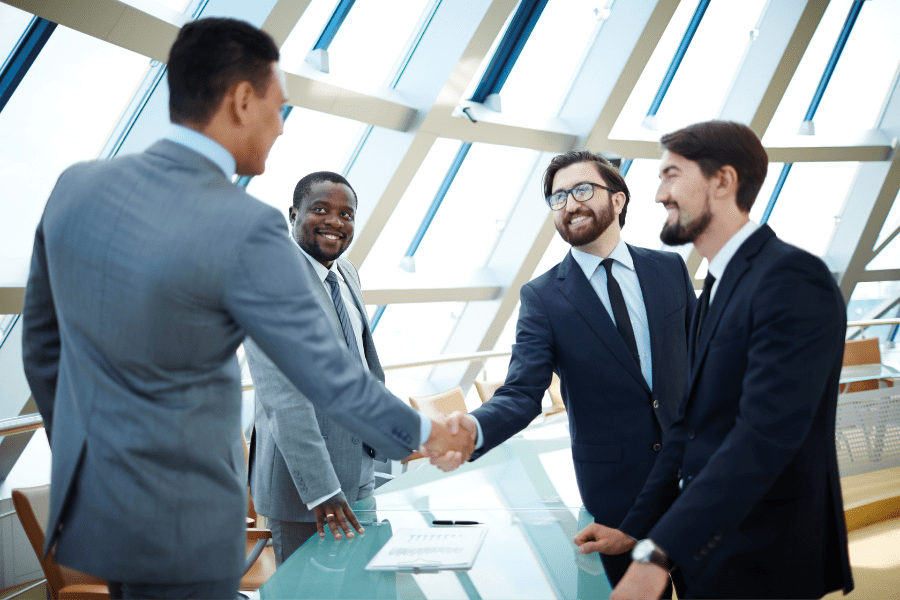 businessmen shaking hands for local partnerships in Africa